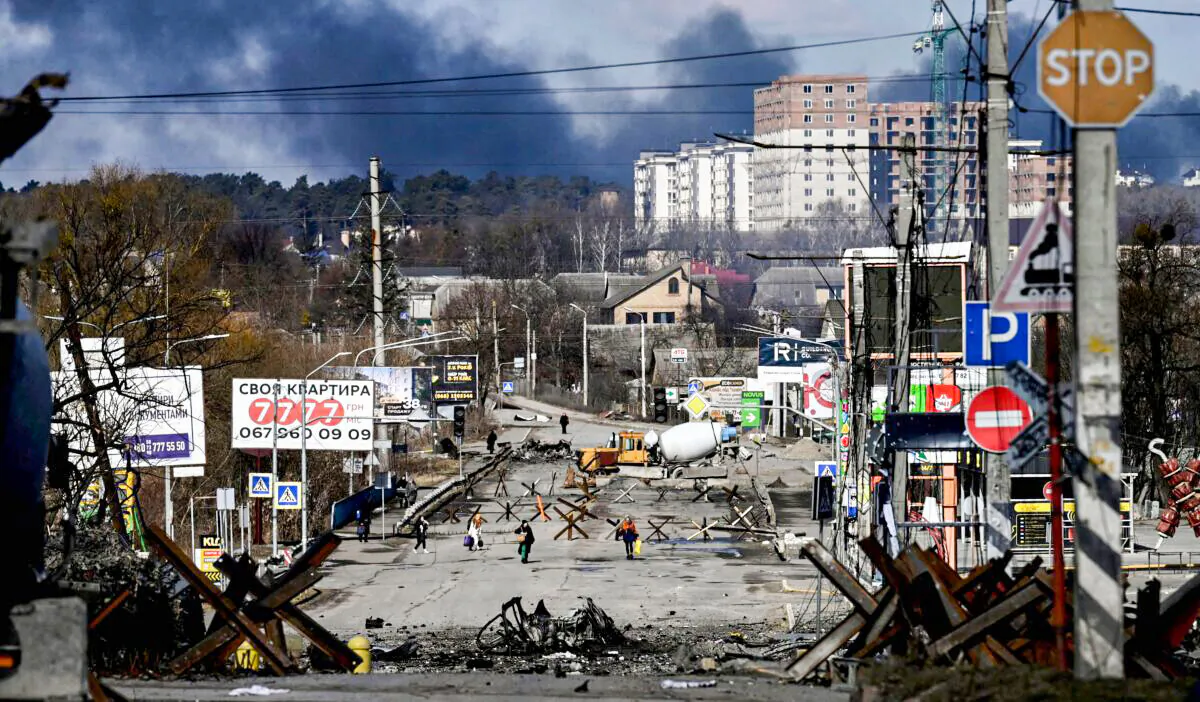 Residents evacuate the city of Irpin, north of Kyiv, Ukraine, on March 10, 2022. (Aris Messinis/AFP via Getty Images)