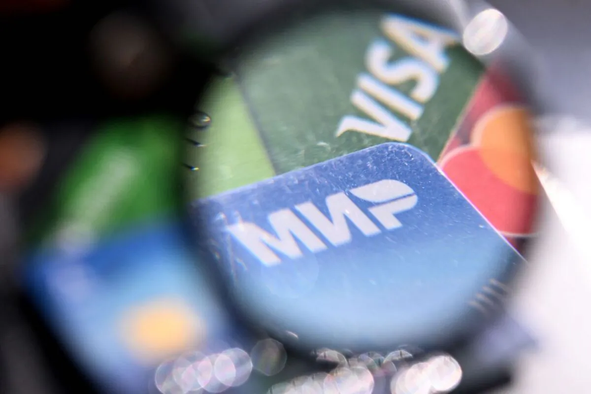 A photo taken on March 14, 2022, shows the logos of Visa, Mastercard and Russian Mir payment systems on bank cards in Moscow. (AFP via Getty Images)