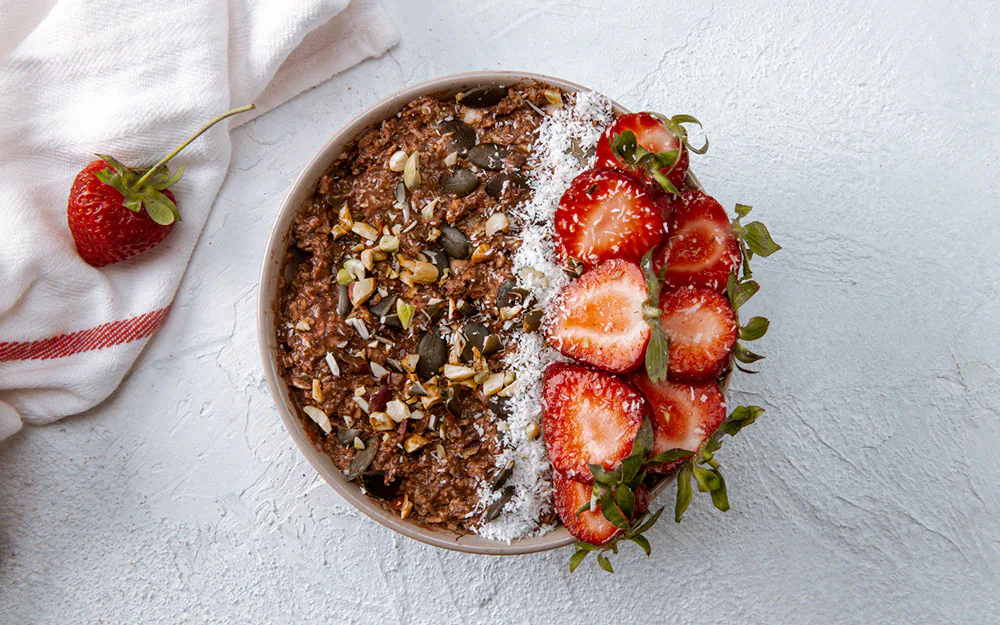 Change your mood by starting your day with a smoothie made from organic coconut water, coconut oil, nut butter, grass-fed collagen, eggs yolks, and frozen berries. (solidcolours/E+/GettyImages)