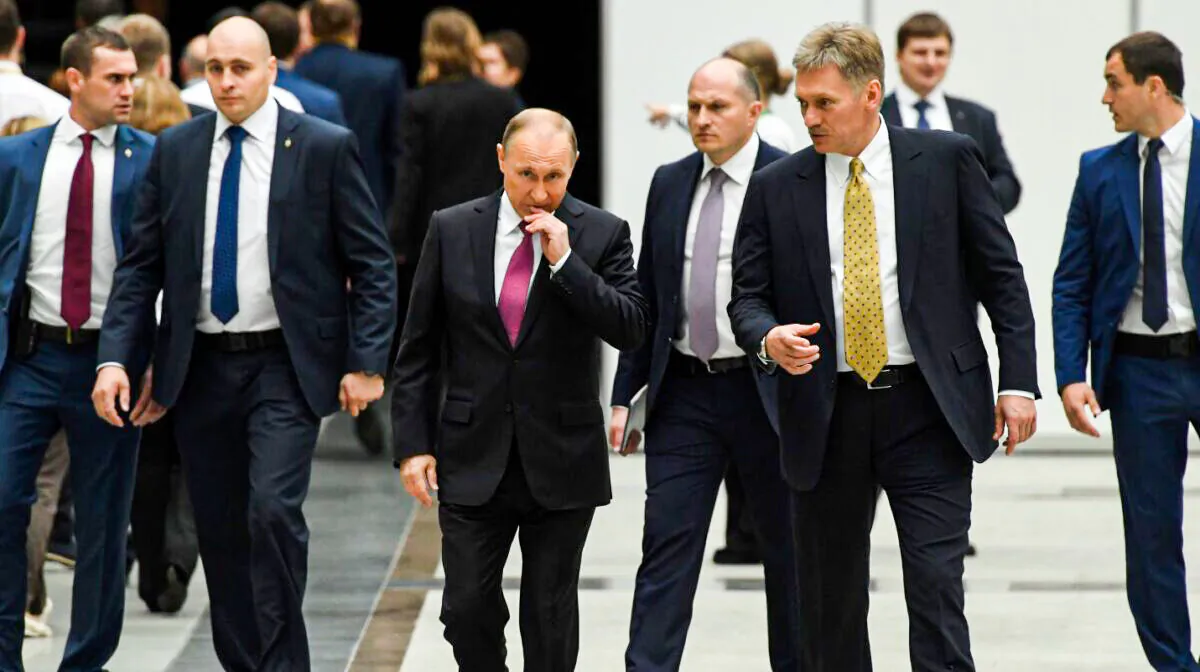 Russian President Vladimir Putin (C) speaks with his press secretary Dmitry Peskov (2nd R) in a file photo. (Kirill Kudryavtsev/AFP via Getty Images)