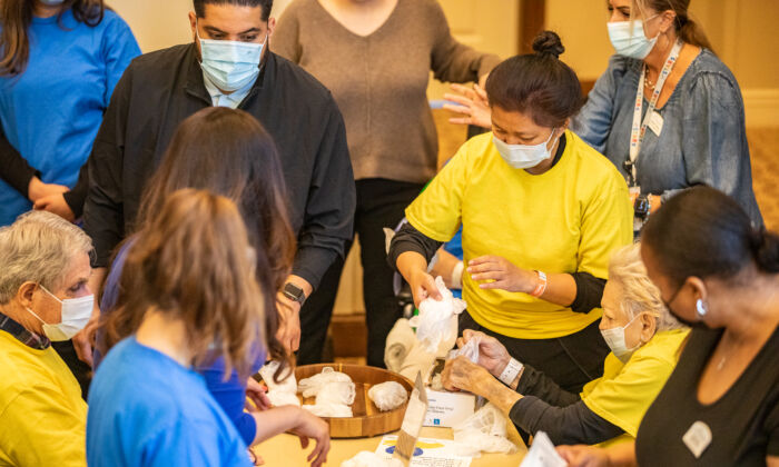 Seniors and medical staff at The Orchards Health Center help create and load first-aid kits to be delivered to Ukraine in Ranch Mission Viejo, Calif., on March 15, 2022. (John Fredricks/The Epoch Times)