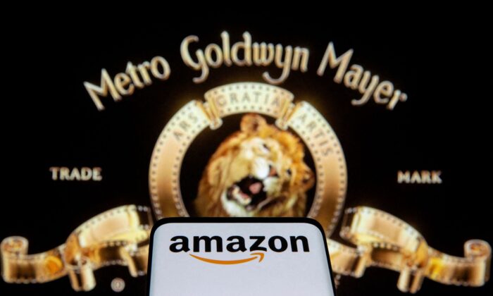 Smartphone with Amazon logo is seen in front of displayed MGM logo in this illustration taken on May 26, 2021. (Dado Ruvic/Reuters Illustration/File Photo)