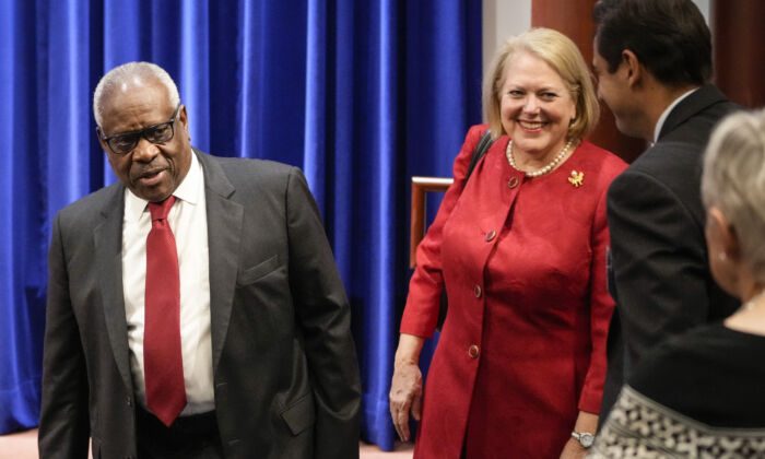 Associate Supreme Court Justice Clarence Thomas and his wife, conservative activist Virginia Thomas, arrive at the Heritage Foundation in Washington on Oct. 21, 2021. (Drew Angerer/Getty Images)