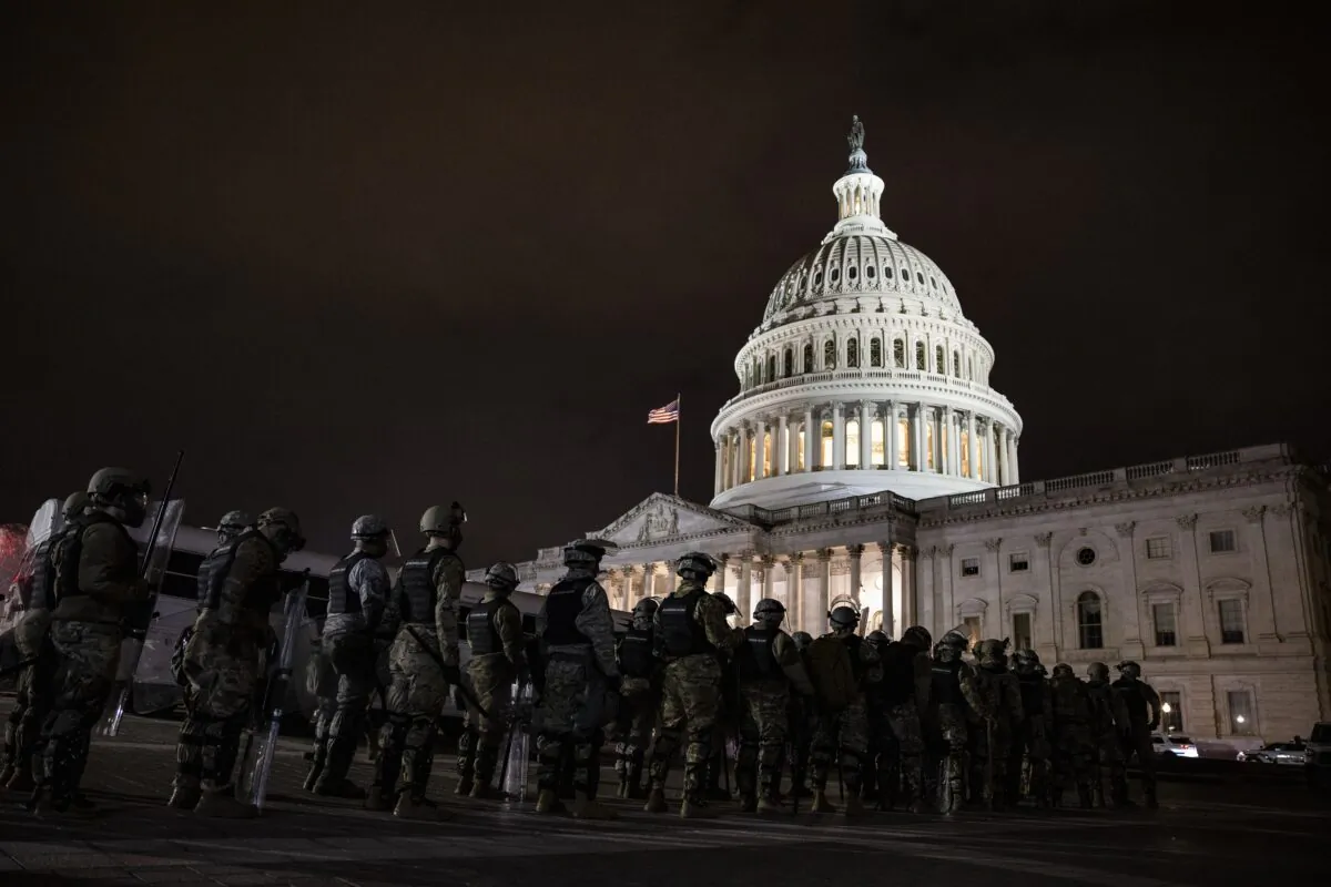 Law enforcement officers and members of the National Guard stand outside the U.S. Capitol on Jan. 6, 2021. (Samuel Corum/Getty Images)