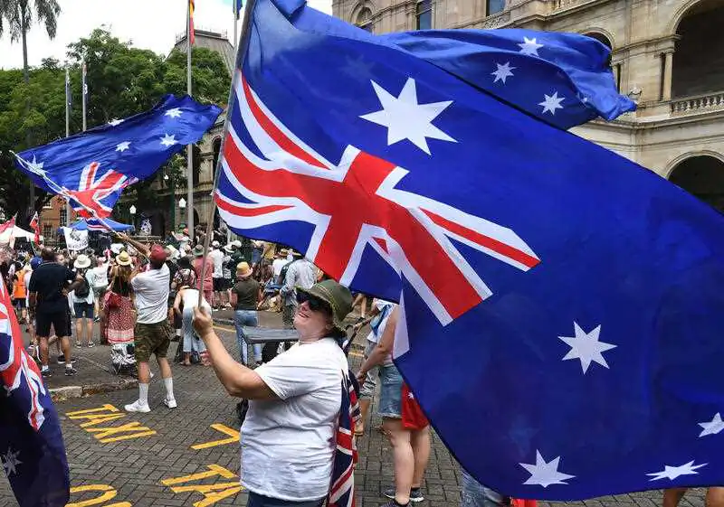 Protesters are seen during an anti-vaccination mandate rally outside Queensland Parliament House in Brisbane, Tuesday, March 15, 2022. (AAP Image/Darren England) 