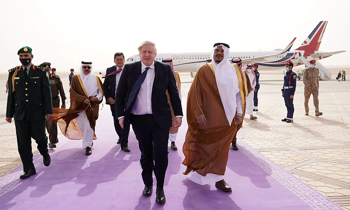 British Prime Minister Boris Johnson (C) arrives at Riyadh Airport during a one-day visit to Saudi Arabia and the United Arab Emirates on March 16, 2022. (Stefan Rousseau / Pool/AFP via Getty Images)