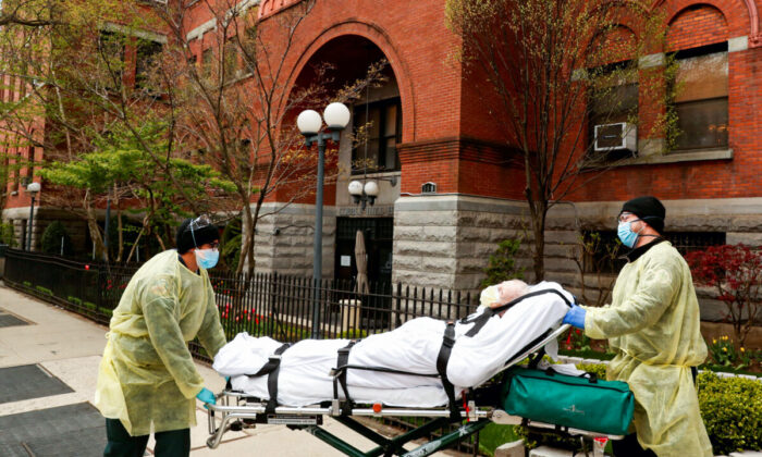 Emergency Medical Technicians (EMTs) wheel a man out of the Cobble Hill Health Center nursing home during an ongoing outbreak of COVID-19 in the Brooklyn borough of New York City on April 17, 2020. (Lucas Jackson/Reuters)