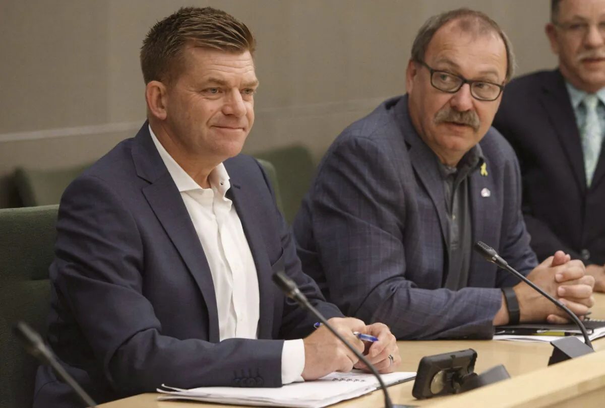 Brian Jean (L), and former house leader of the Progressive Conservatives Ric McIver sit together during the first meeting of the new United Conservative Party caucus in Edmonton Alta, on July 24, 2017. (The Canadian Press/Jason Franson)