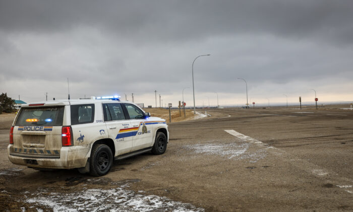 A police vehicle looks out over an empty highway after protesters opposing federal COVID-19 mandates left following their blockade of the highway at the busy U.S. border crossing in Coutts, Alberta, on Feb. 15, 2022. (The Canadian Press)