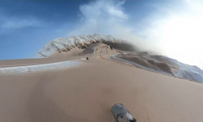 Snowboarder Sam Estebe cut through dusty snow and left a bright white path at the Pierwengarly Ski Station in the Pyrenees, France, on March 15, 2022.  (Screenshot via Sam Esteve / UGC / AP / Epoch Times)