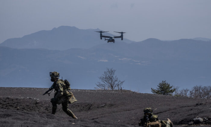 A U.S. Marine Corp Osprey comes in to land next to soldiers from Japans 1st Amphibious Rapid Deployment Brigade during an exercise with the U.S. 31st Marine Expeditionary Unit in Gotemba, Japan on March 15, 2022. (Carl Court/Getty Images)
