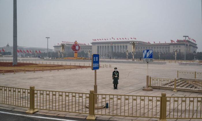 A police officer stands guard in Tiananmen Square before the closing session of the National People's Congress at the Great Hall of the People in Beijing, China, on March 11, 2022. (Kevin Frayer/Getty Images)
