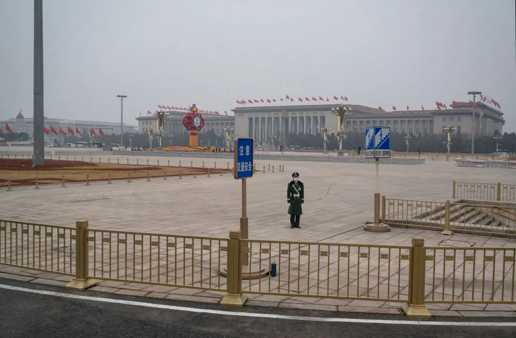 A police officer stands guard in Tiananmen Square before the closing session of the National People's Congress at the Great Hall of the People in Beijing on March 11, 2022. (Kevin Frayer/Getty Images)
