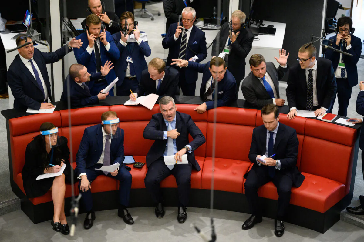Traders, brokers and clerks shout and gesture on the first day of in-person trading at the London Metal Exchange (LME) on Sept. 6, 2021. (Leon Neal/Getty Images)