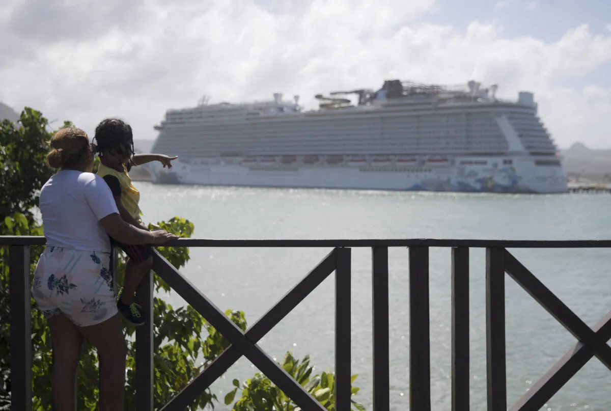 People look at the Norwegian Escape cruise ship at the Taino Bay Port, in Puerto Plata, Dominican Republic, on March 15, 2022. (Erika Santelices/AFP via Getty Images)