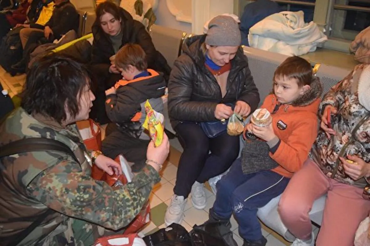 Yi Qiwei (first from left) with Ukrainian refugees in Medyka in March 2022. (Supplied by Genkyo Team)