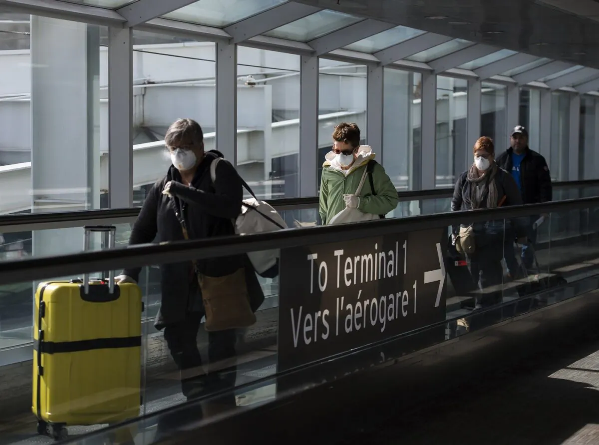 People leave the terminal after arriving at Pearson International Airport in Toronto on March 16, 2020. (The Canadian Press/Nathan Denette)