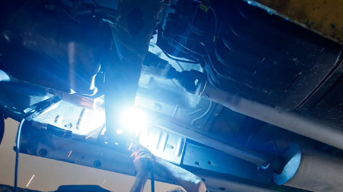 A man works on replacing a catalytic converter on a truck in Davie, Fla., on Dec. 7, 2009. (Joe Raedle/Getty Images)