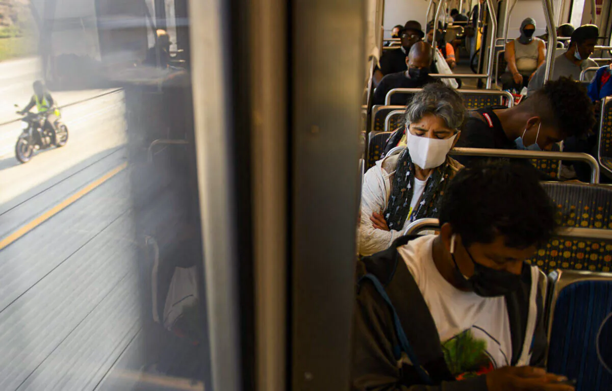 Transit passengers wear face masks as they ride a light rail train in Los Angeles, Calif., on July 16, 2021. (Patrick T. Fallon/AFP via Getty Images)
