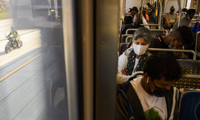 Transit passengers wear face masks as they ride a light rail train in Los Angeles, California, on July 16, 2021. (Patrick T. Fallon/AFP via Getty Images)