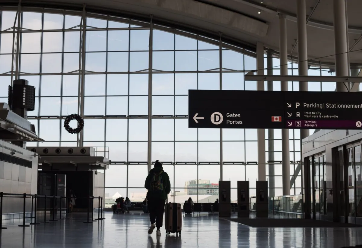 Travellers are photographed at Toronto Pearson International Airport, on Dec. 16, 2021. (The Canadian Press/Tijana Martin)