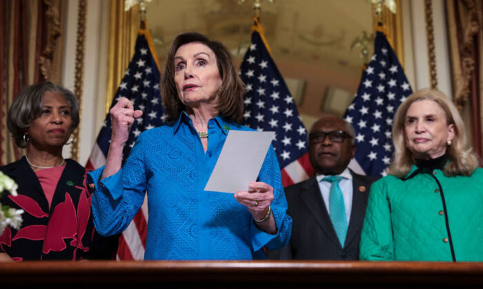 (L–R) Rep. Brenda Lawrence (D-Mich.), Speaker of the House Nancy Pelosi (D-Calif.), Rep. James Clyburn (D-S.C.), and Rep. Carolyn Maloney (D-N.Y.) participate in a bill enrollment ceremony for the Postal Service Reform Act, H.R. 3076, at the U.S. Capitol in Washington on March 17, 2022. (Kevin Dietsch/Getty Images)