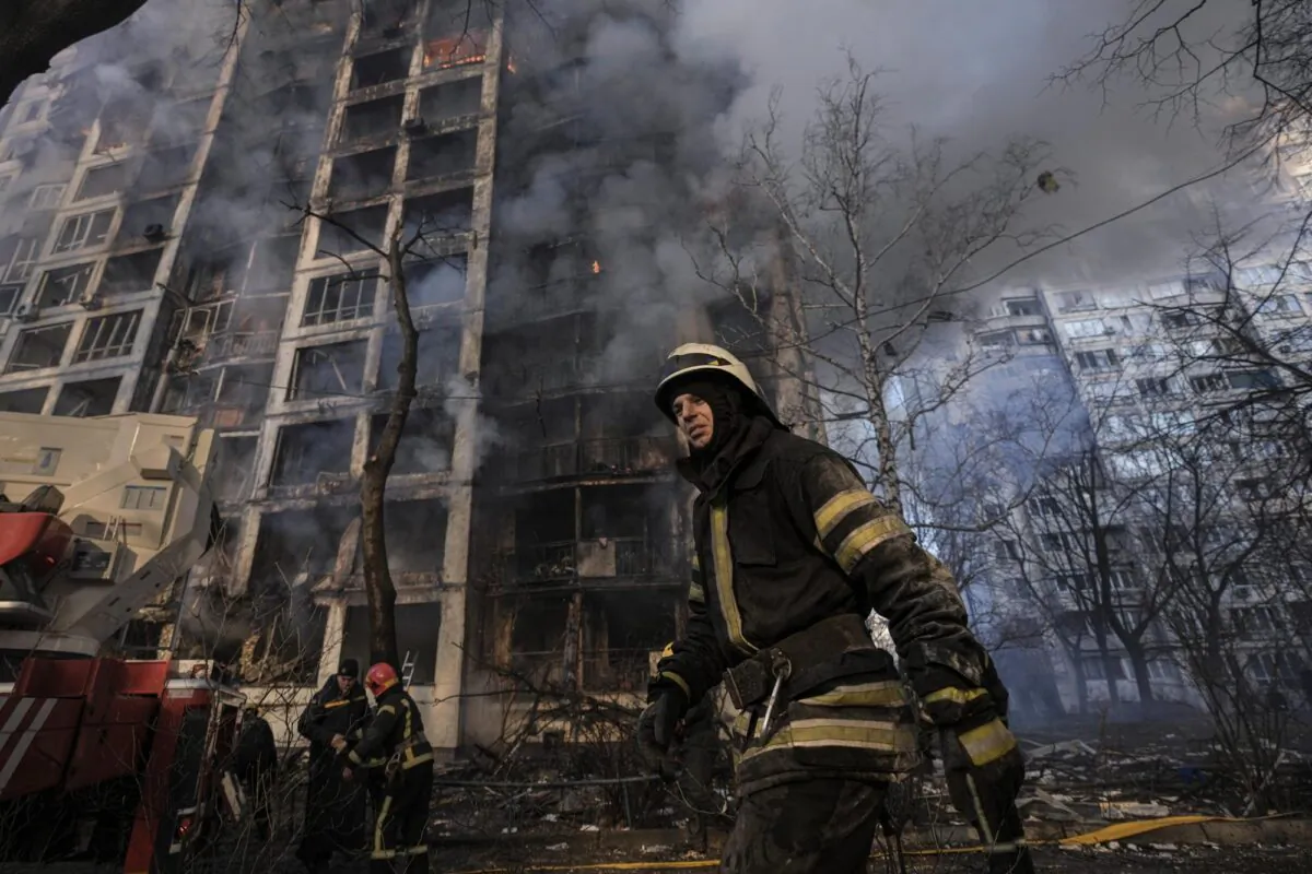 A firefighter walks outside a destroyed apartment building after a bombing in a residential area in Kyiv, Ukraine, on March 15, 2022. (Vadim Ghirda/AP Photo)