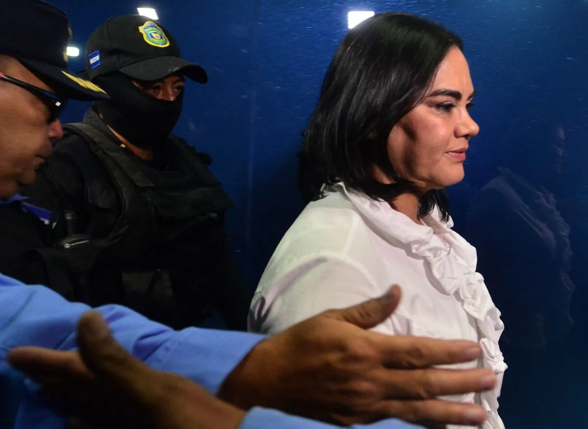 Former Honduran President Porfirio Lobo's ex wife Rosa Elena Bonilla is escorted after being found guilty of the misappropriation of public funds destined to social programs during Lobo's term (2010-2014) by a court in Tegucigalpa, Honduras, on Aug. 20, 2019. (Orlando Sierra/AFP via Getty Images)