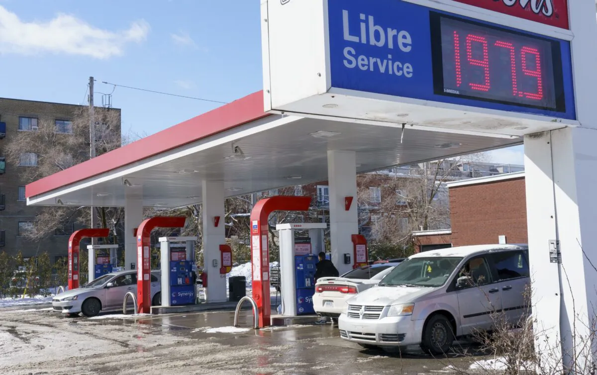 Motorists fill up at a gas station in Montreal on March 8, 2022. (The Canadian Press/Paul Chiasson)