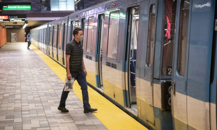 A commuter boards a subway train from an empty platform in Montreal, May 25, 2020. (The Canadian Press/Paul Chiasson)