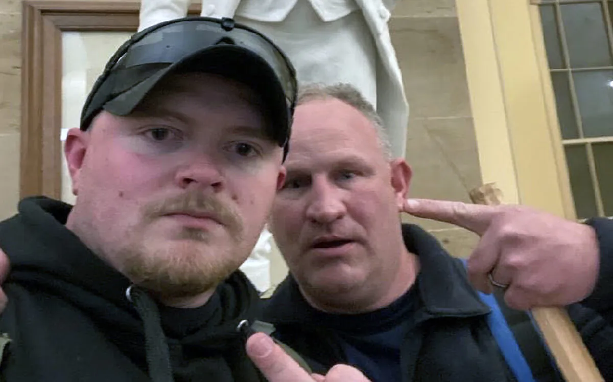 Jacob Fracker, 30, a former Virginia police officer, pleaded guilty to a felony charge of conspiracy to obstruct counting of electoral votes on Jan. 6, 2021. He posed for this selfie with co-defendant Thomas Robertson in the Capitol Crypt. (U.S. Department of Justice/Screenshot via The Epoch Times)
