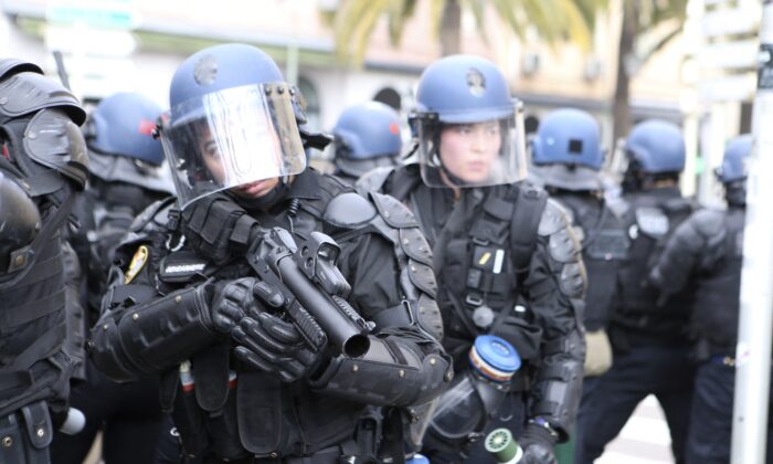 Gendarme stand with LBD guns at the city's main square, close to the prefecture, after a protest march to support Yvan Colonna's family after the assault of the pro-independence activist in an Arles' prison, in Ajaccio, on the French Mediterranean island of Corsica, on March 8, 2022. (Pascal Pochard-Casablanca/AFP via Getty Images)