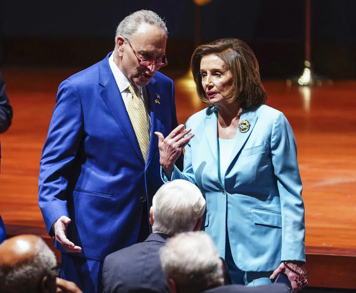 Senate Majority Leader Chuck Schumer (D-N.Y.) talks to House Speaker Nancy Pelosi (D-Calif.) at the Capitol in Washington on March 16, 2022. (Sarah Silbiger/Getty Images)