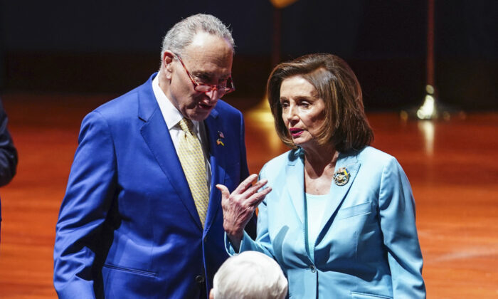 Senate Majority Leader Chuck Schumer (D-N.Y.) talks to House Speaker Nancy Pelosi (D-Calif.) at the Capitol in Washington on March 16, 2022. (Sarah Silbiger/Getty Images)