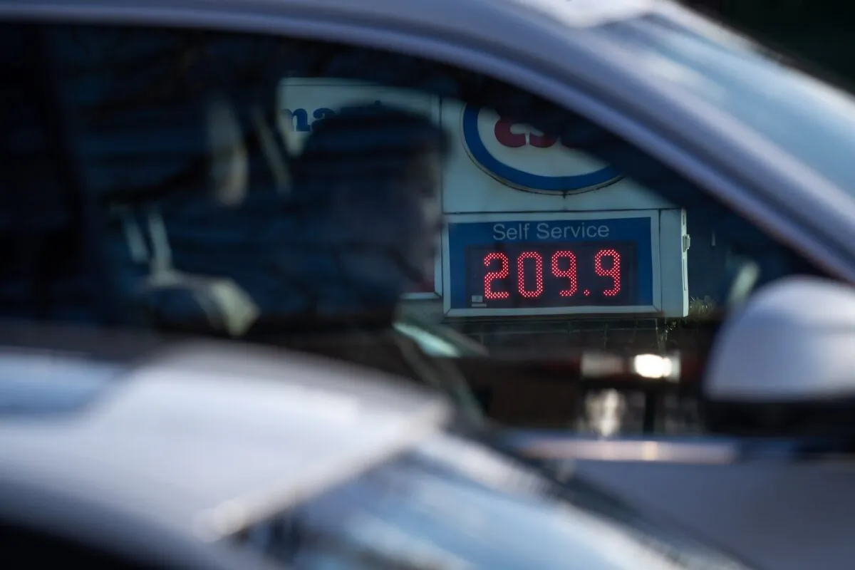 A sign displays the price of a litre of regular grade gasoline at an Esso gas station as a motorist waits at a red light, in Vancouver, on March 8, 2022. (The Canadian Press/Darryl Dyck)