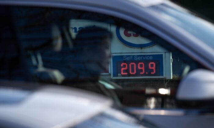 A sign displays the price of a litre of regular grade gasoline at an Esso gas station as a motorist waits at a red light, in Vancouver, on March 8, 2022. (The Canadian Press/Darryl Dyck)