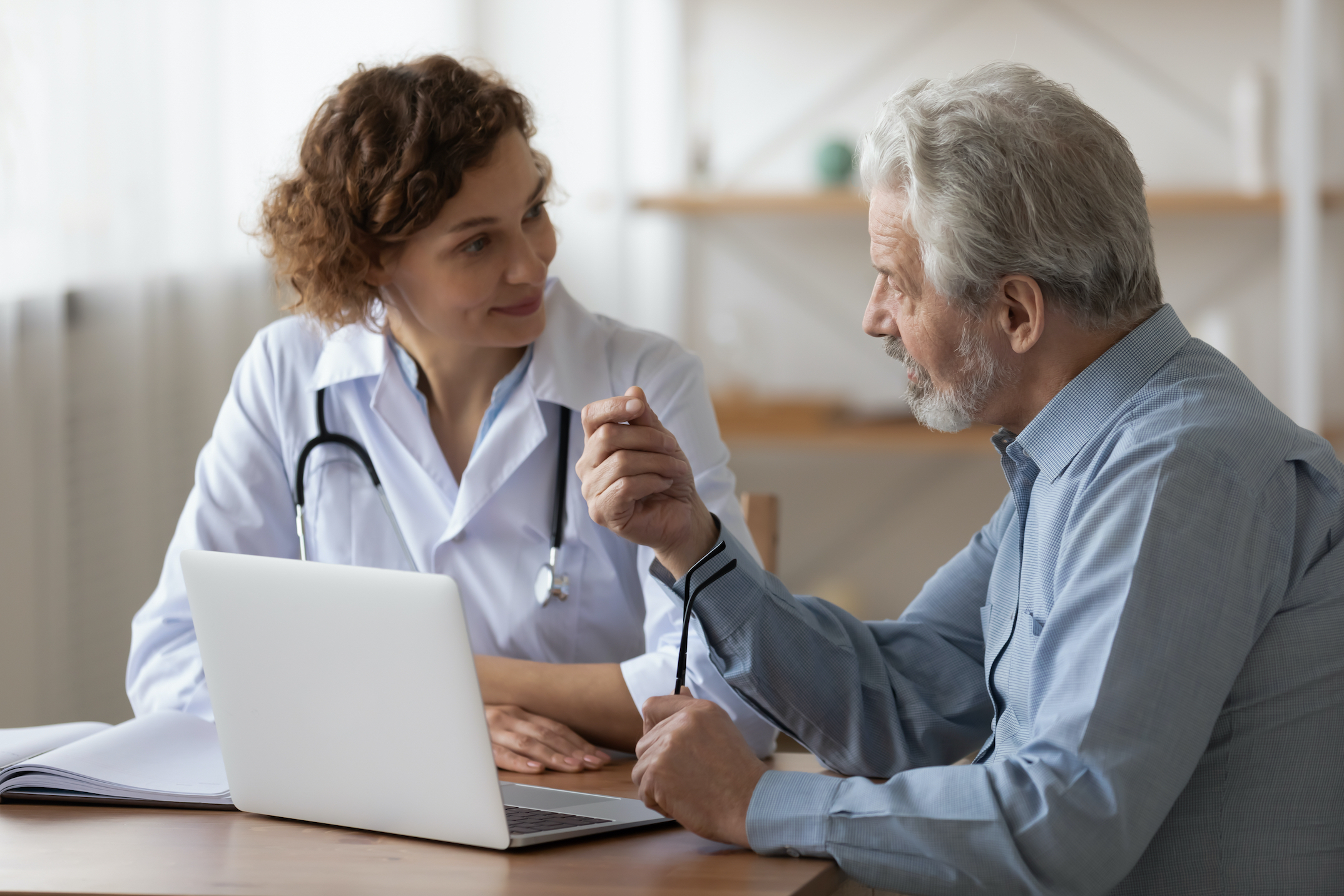 Serious,Middle,Aged,Retired,Man,Consulting,With,Young,Female,Physician