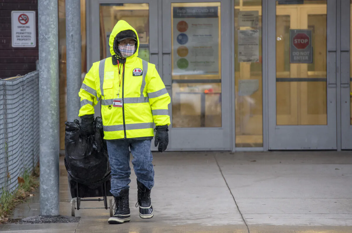 A crossing guard leaves Thorncliffe Park Public School in Toronto on Nov. 30, 2020. (The Canadian Press/Frank Gunn)