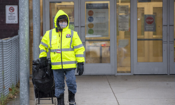 A crossing guard leaves Thorncliffe Park Public School in Toronto on Nov. 30, 2020. (The Canadian Press/Frank Gunn)