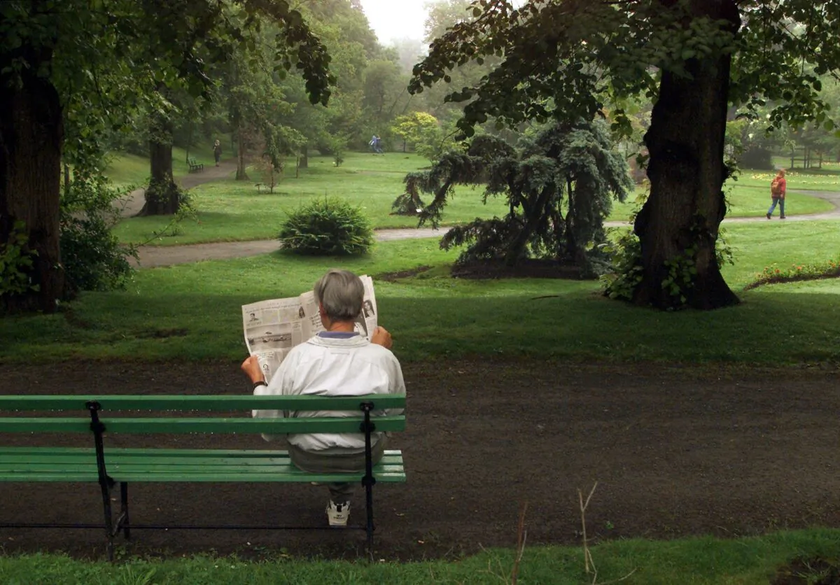 A man reads a newspaper in the Halifax Public Gardens in Halifax in this file photo. (CP Photo/Andrew Vaughan)
