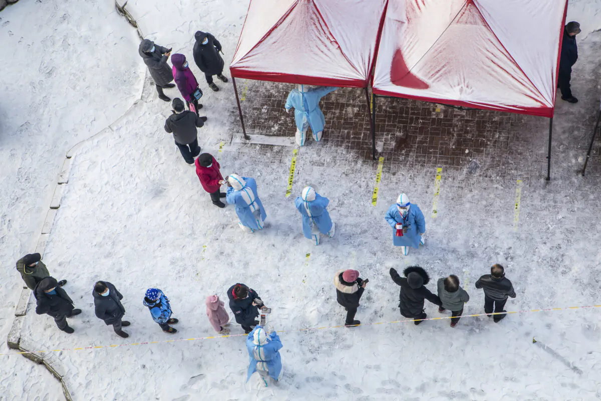 Residents queue to undergo nucleic acid tests for the COVID-19 in Jilin in China's northeastern Jilin Province on March 15, 2022. (STR/AFP via Getty Images)