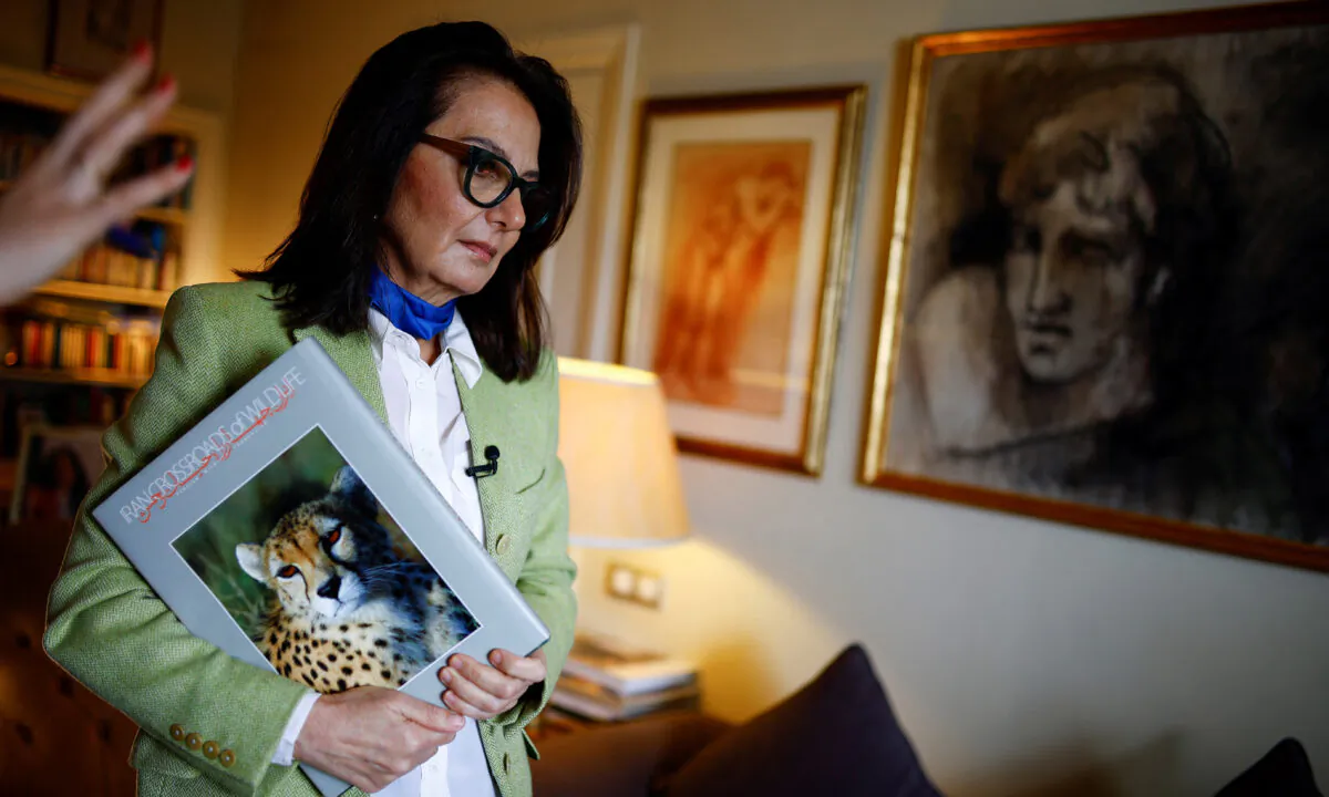 Tahrane Tahbaz, sister of detained Iranian-American environmentalist Morad Tahbaz, who also holds British citizenship, holds a book that her brother made, after talking with Reuters at her home in Madrid on March 18, 2022. (Juan Medina/Reuters)