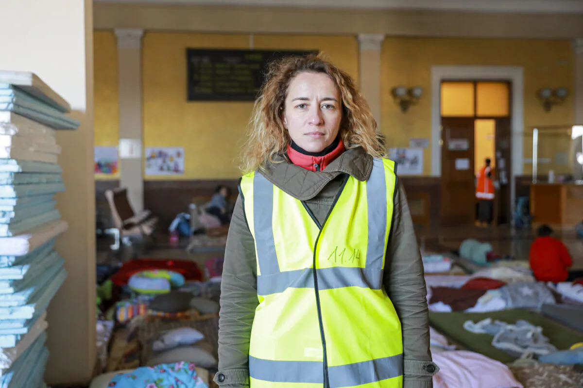 Anna Pryimenko, a volunteer, stands in a room for refugee mothers and children at the train station in Lviv, Ukraine, on March 18, 2022. (Charlotte Cuthbertson/The Epoch Times)