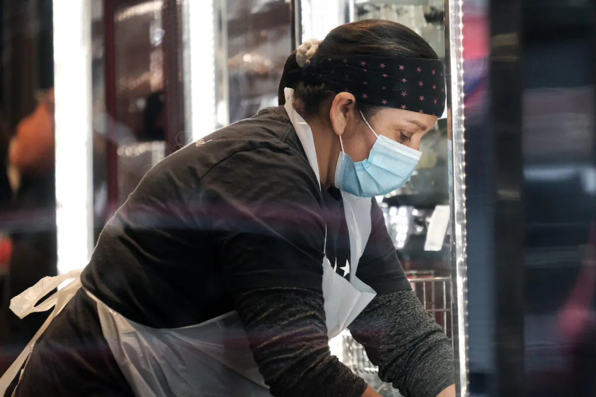Workers at a restaurant wear masks in lower Manhattan on the day that a mask mandate went into effect in New York City on Dec. 13, 2021. (Spencer Platt/Getty Images)