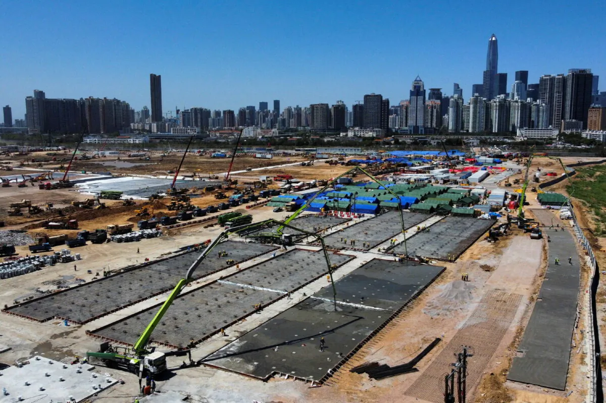 A general view of the high-rise buildings in Shenzhen and construction site of a COVID-19 isolation facility in Lok Ma Chau, during the COVID-19 pandemic in Hong Kong, on March 9, 2022. (Tyrone Siu/Reuters)