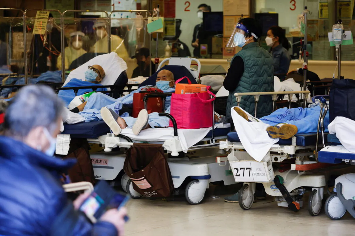 Patients wearing masks rest at a hospital in Hong Kong on March 3, 2022. (Tyrone Siu/Reuters)