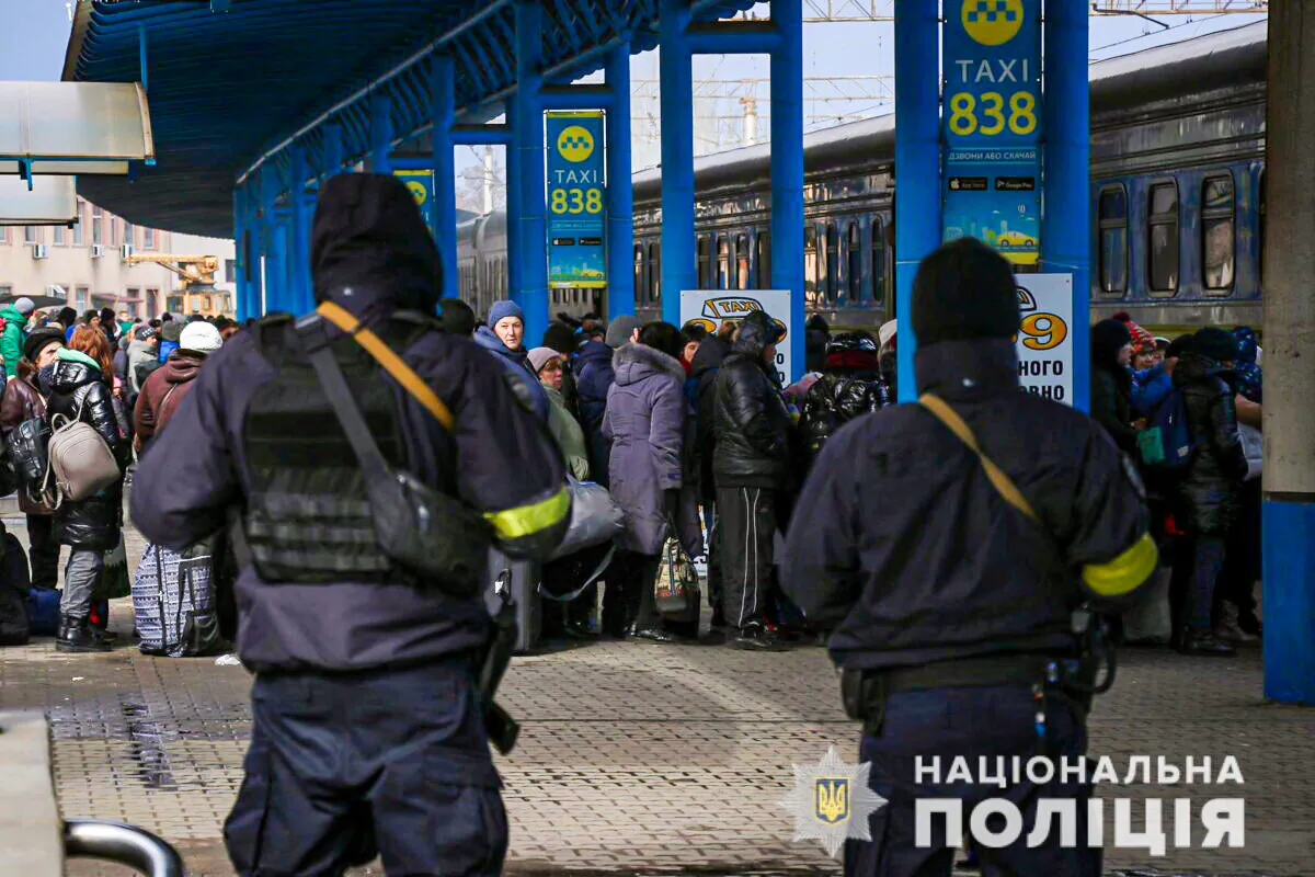 People fleeing from Mariupol amid Russia's invasion of Ukraine stand at a railway station in Zaporizhzhia, Ukraine, in this handout picture obtained by Reuters on March 16, 2022. (Press service of the National Police of Ukraine/Handout via Reuters)