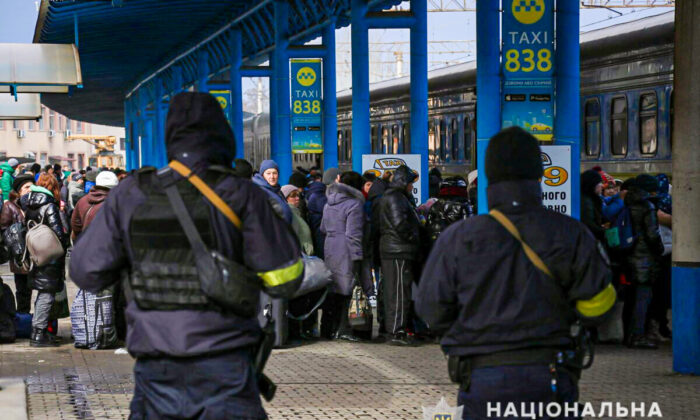 People fleeing from Mariupol amid Russia's invasion of Ukraine stand at a railway station in Zaporizhzhia, Ukraine, in this handout picture obtained by Reuters on March 16, 2022. (Press service of the National Police of Ukraine/Handout via Reuters)