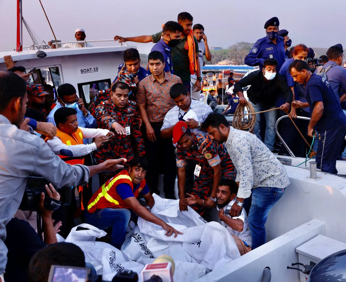 A relative of one of the victims mourns as a ferry sank after colliding with a sand carrier ship in Narayanganj, Bangladesh, on March 20, 2022. (Mohammad Ponir Hossain/Reuters)