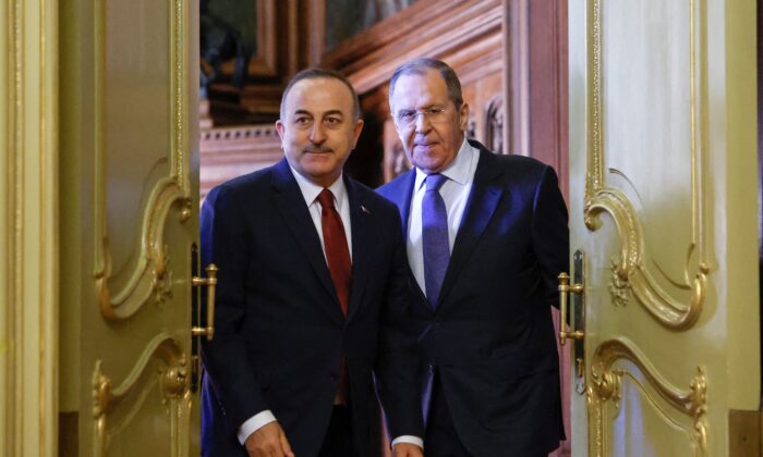 Russian Foreign Minister Sergei Lavrov (R) and his Turkish counterpart Mevlut Cavusoglu arrive to hold a joint press conference following their talks in Moscow on March 16, 2022. (Maxim Shemetov/Pool/AFP via Getty Images)